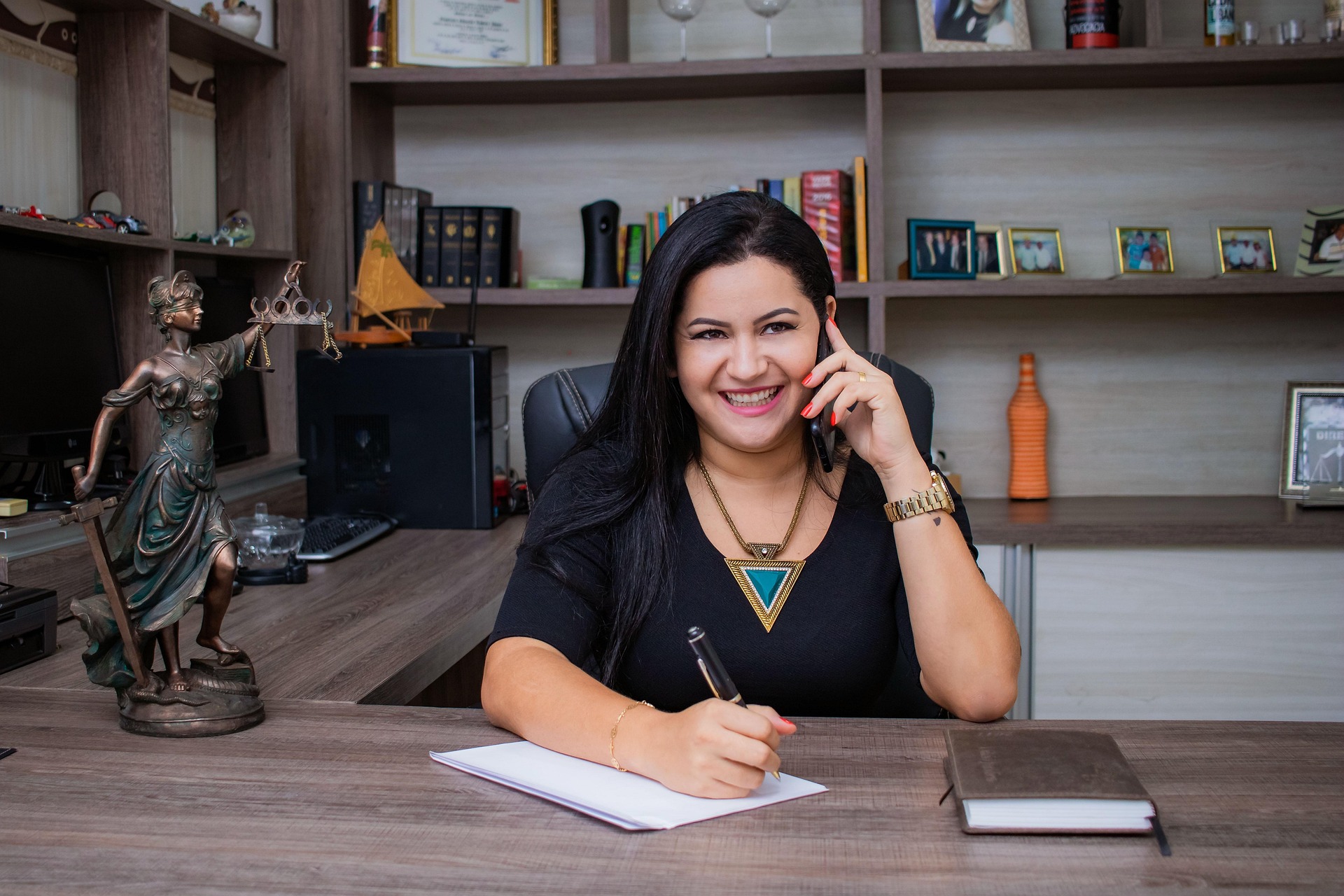 An attorney reaching for a phone at a desk