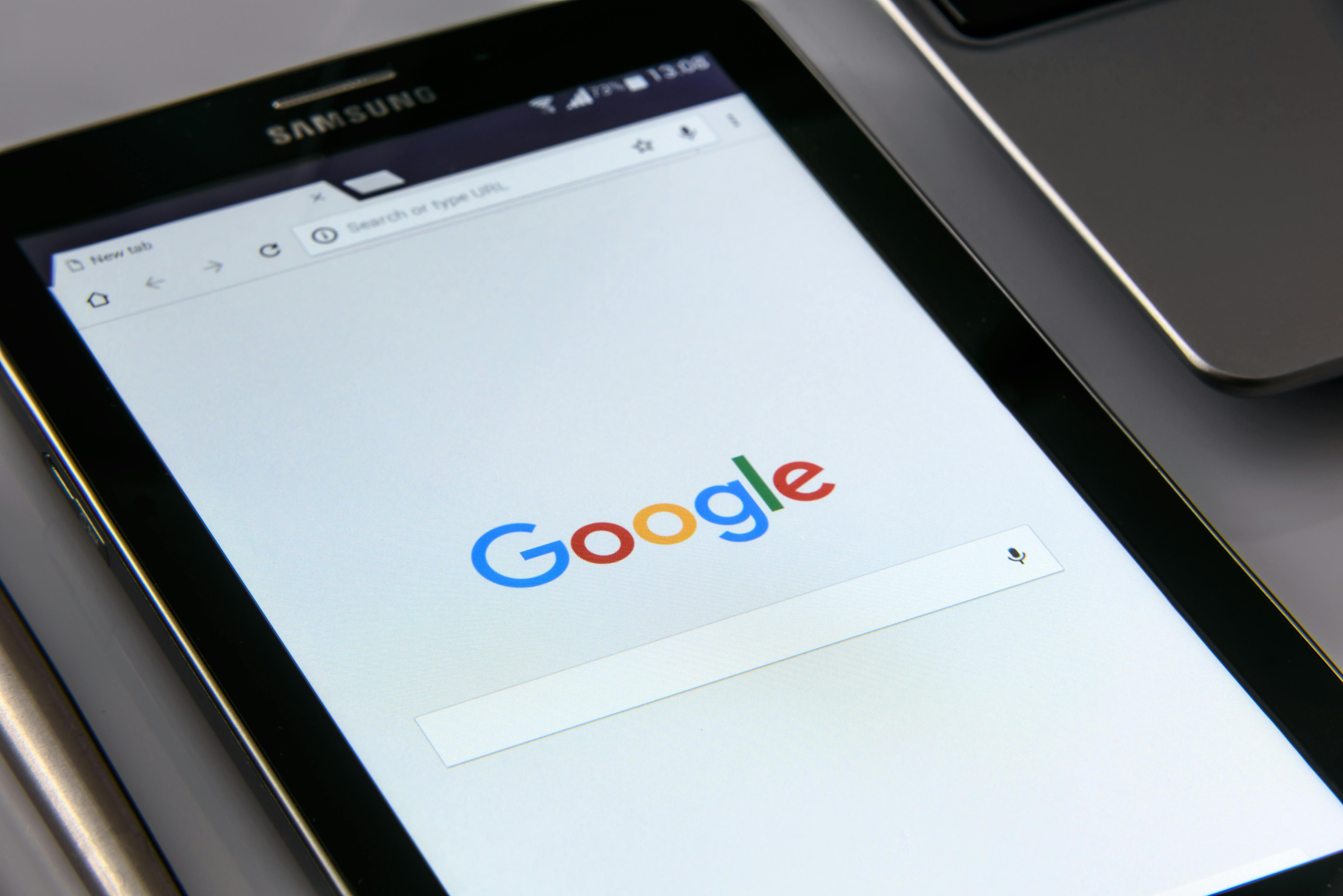 Samsung tablet laying flat showing Google homepage in a browser