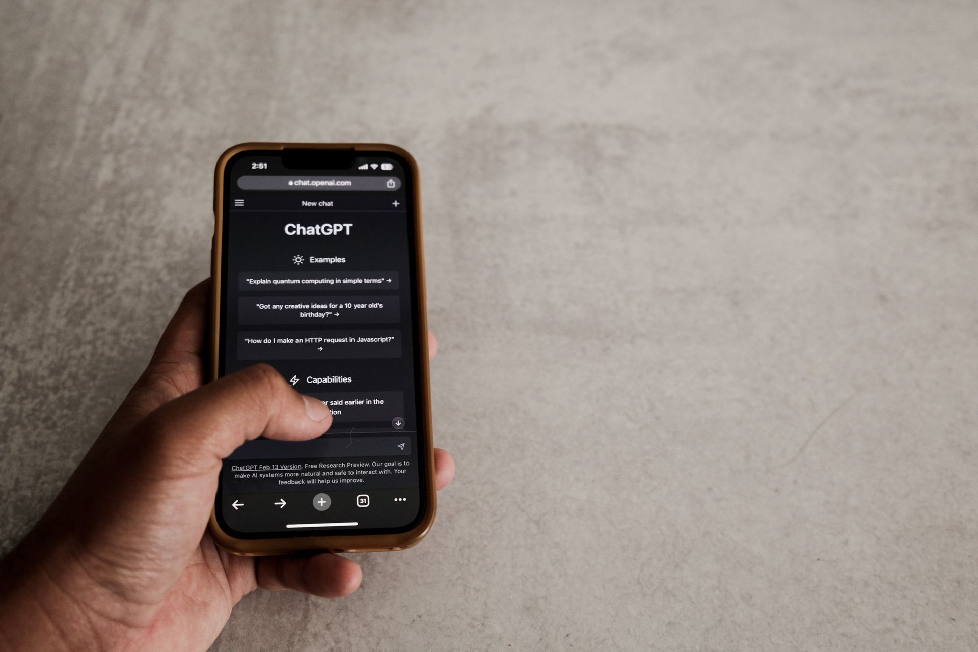 Hand holding a smartphone with ChatGPT open in a mobile browser