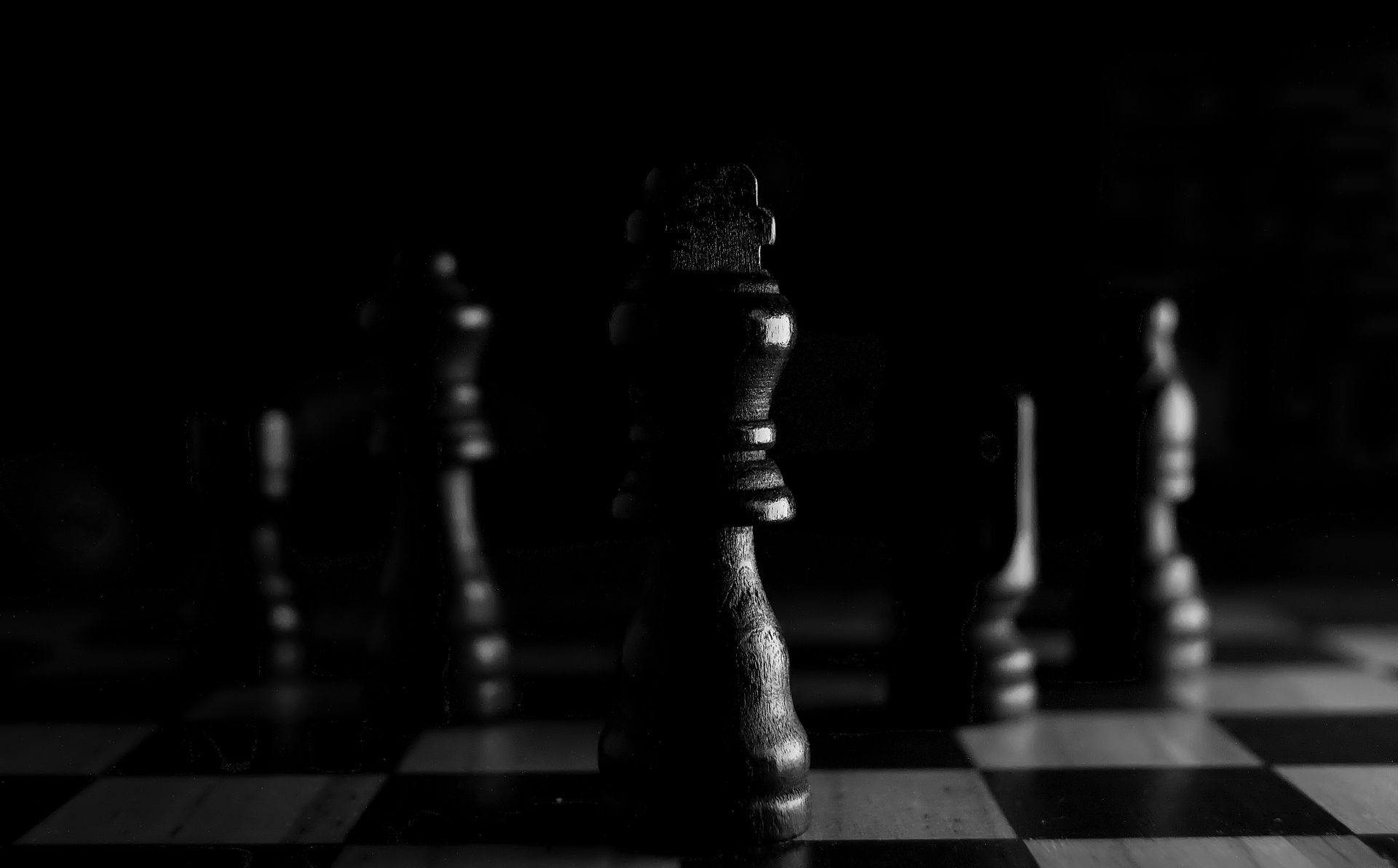 Black chess piece standing on a chessboard