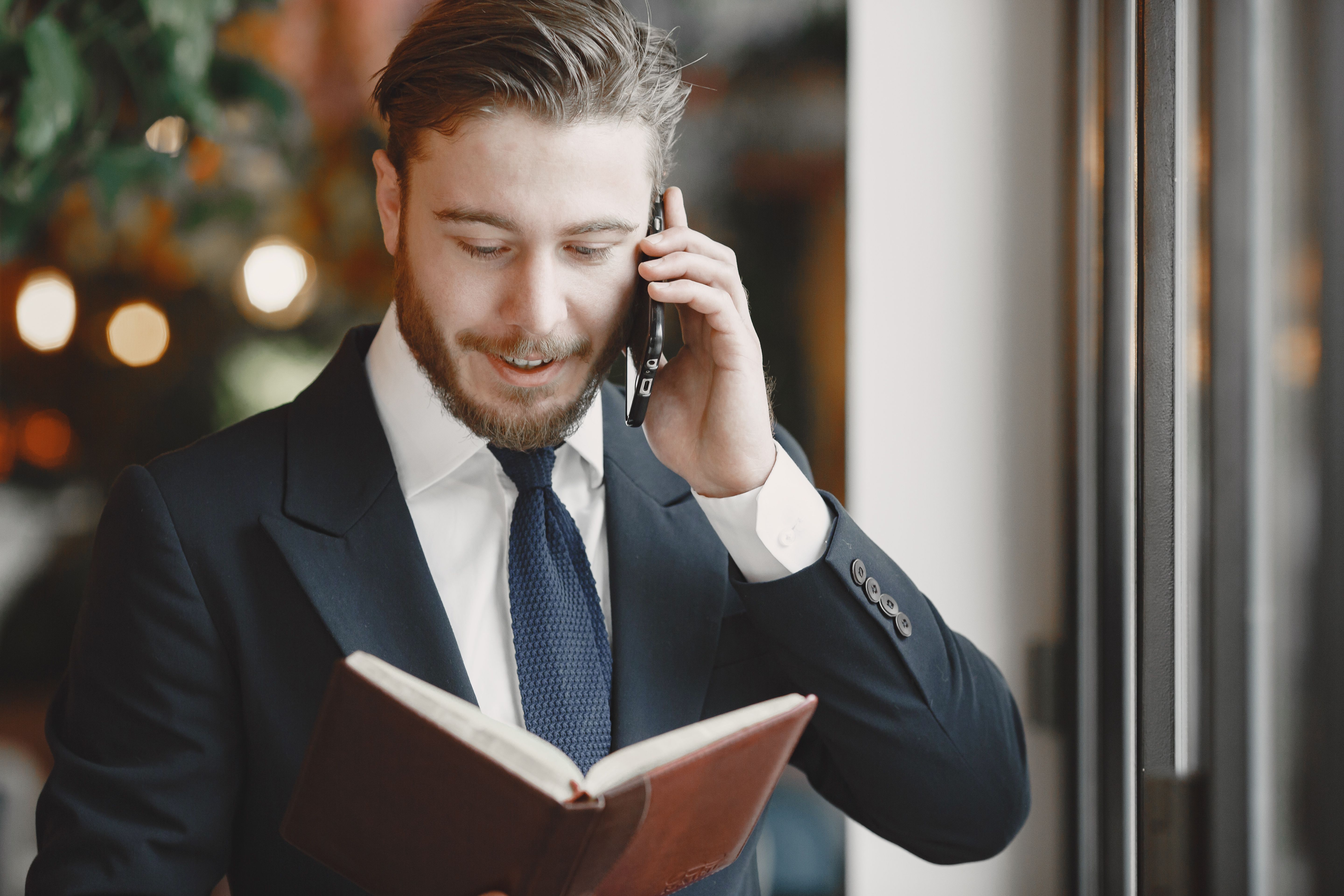 Attorney in a suit on a phone call while reviewing notes