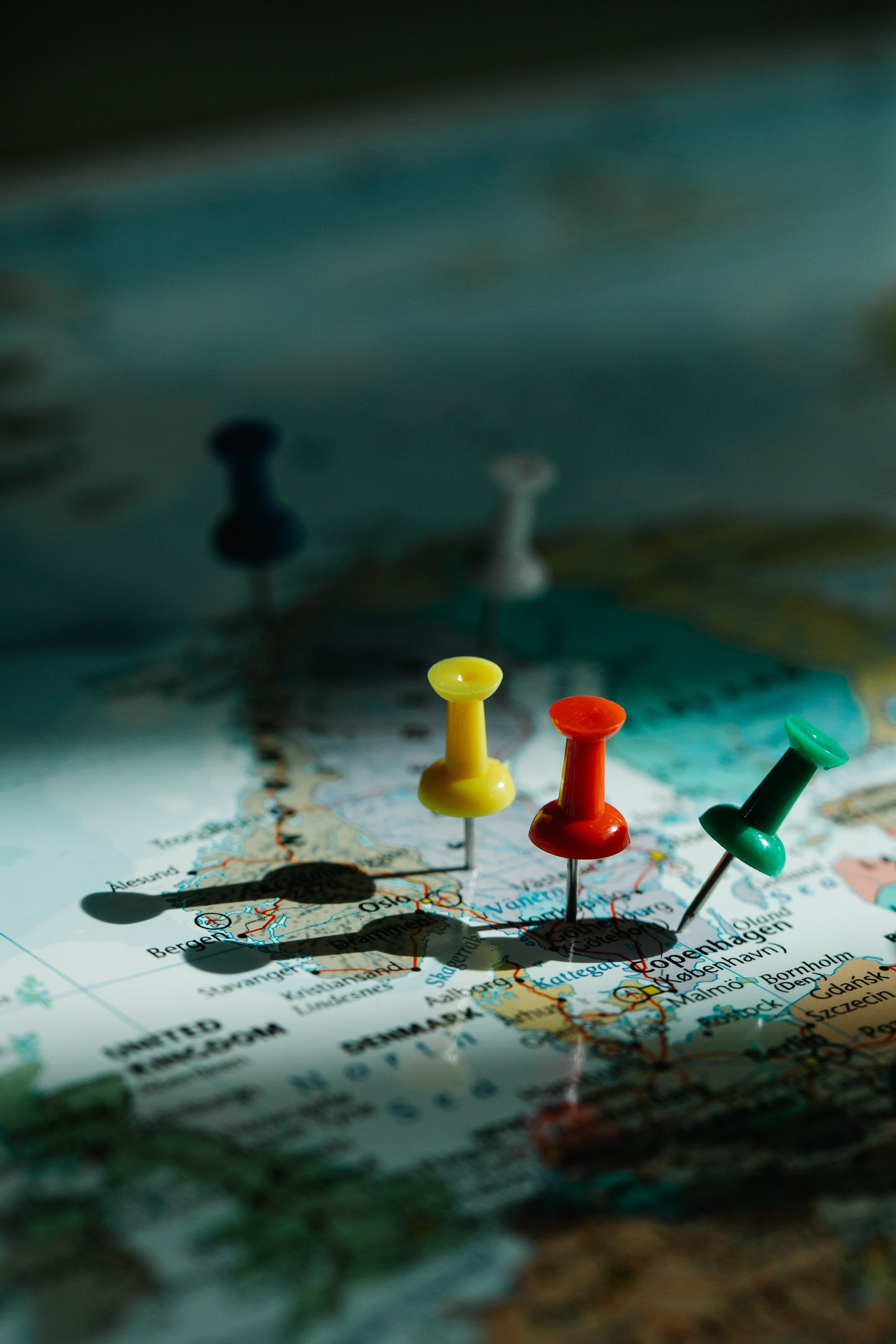 Colorful push pins marking locations on a map