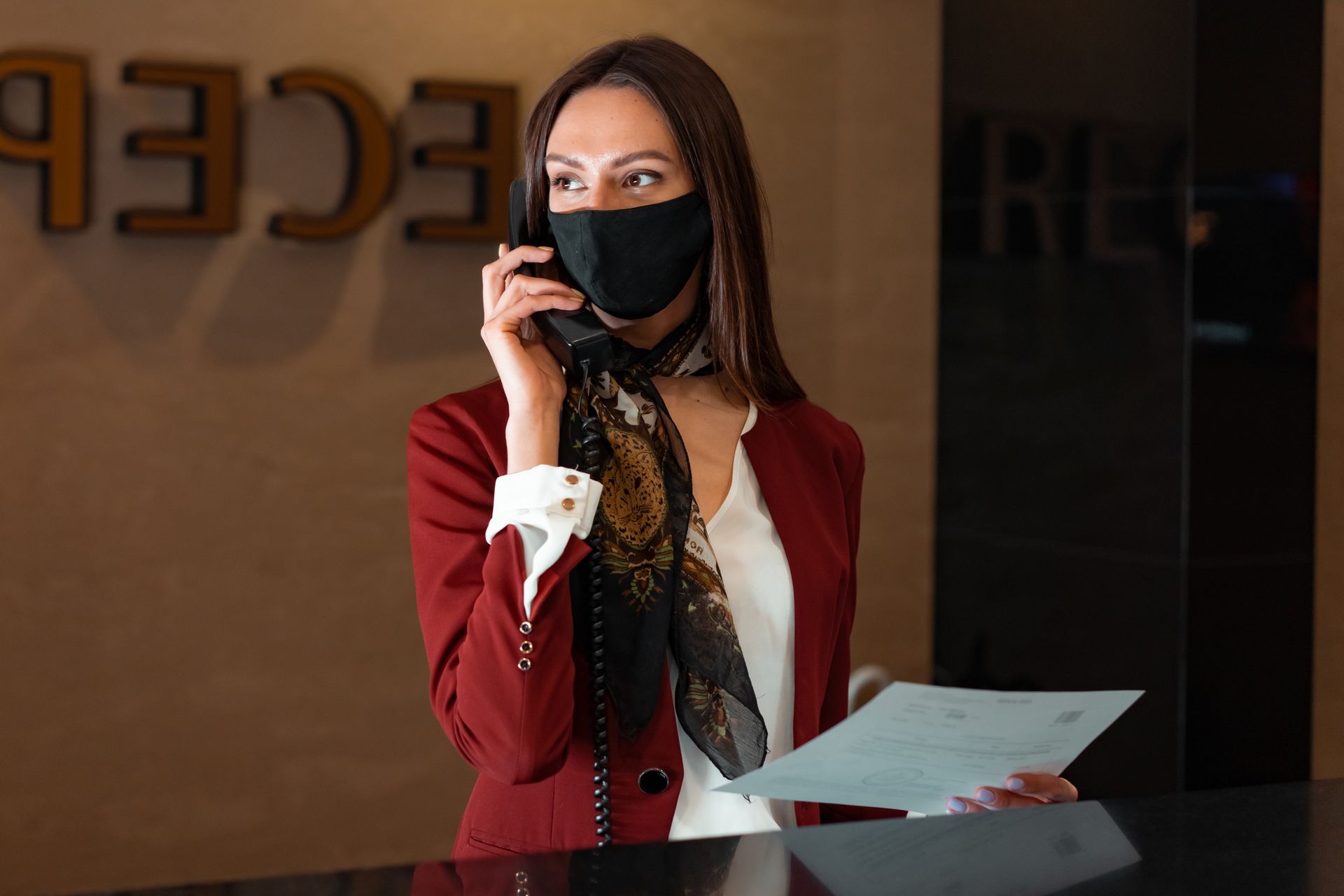 Receptionist answering a phone call at a front desk